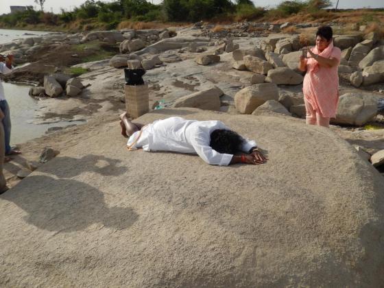 Mohanji Prostrating to SriPada Sri Vallabhab “on the rock” which was used by SriPada Sri Valabha to do SuryaNamaskar every morning. It is said that that such was the ‘Tej’ of Sri Pada, Sri Valabha that the color of the rock darkened. In this picture Preeti is also clicking another one.